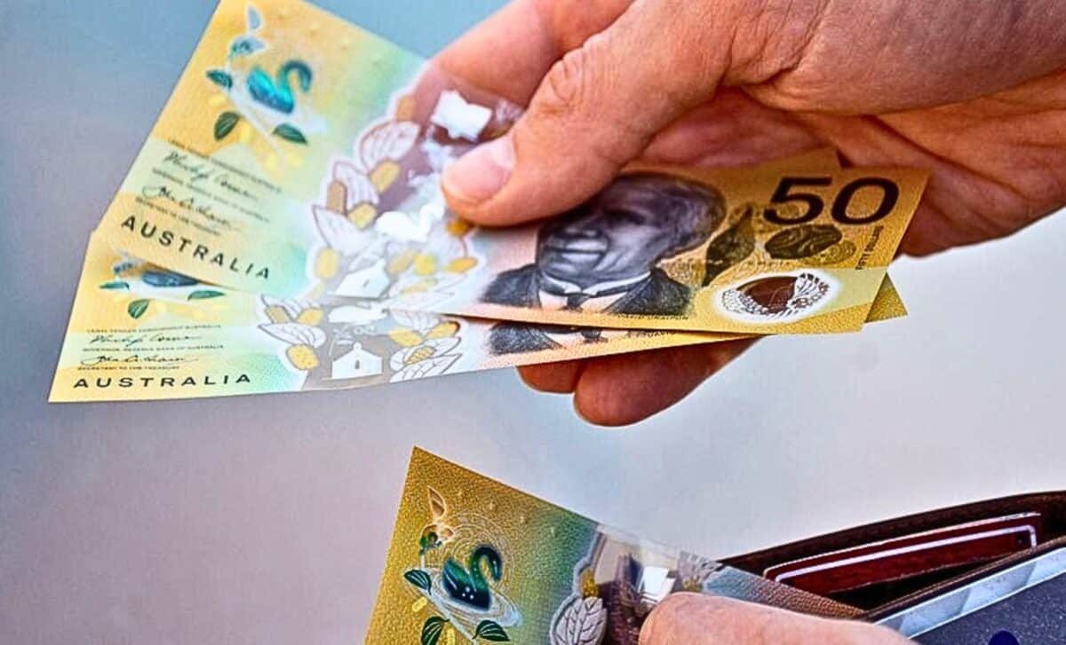 A person with Australian money in his hand