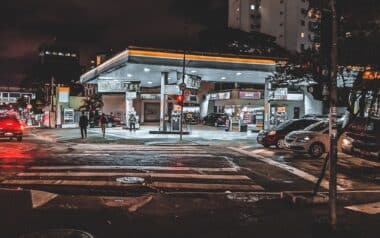 Busy urban street with traffic on and gas station near Fuel Price