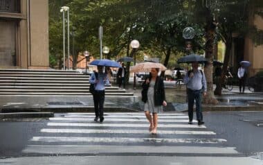 pedestrians crossing a street in the rain