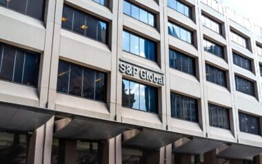 The facade of a modern office building prominently displaying the S&P Global logo