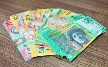 Many Notes of Australian Currency on Wooden Surface Background