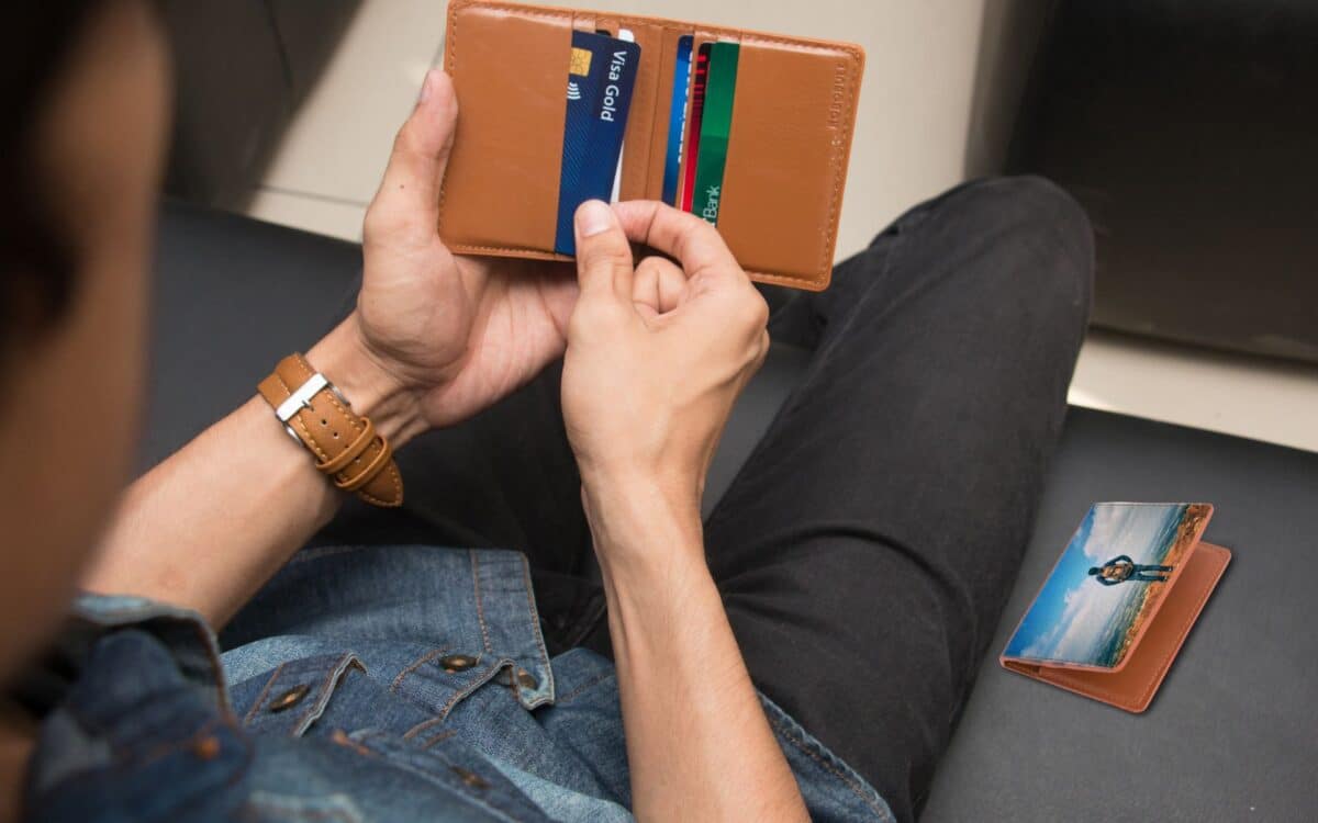 Close-Up Shot of a Person Holding a Brown Wallet with Credit Cards