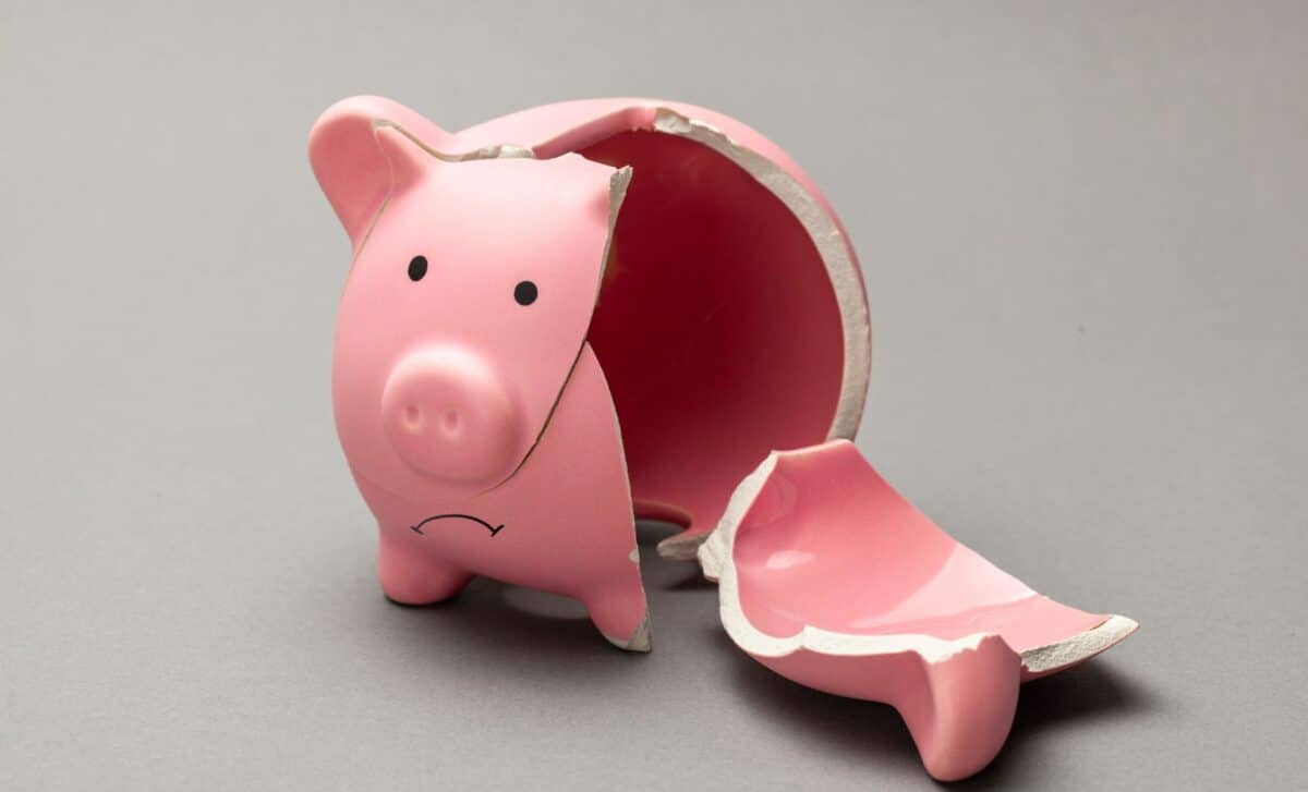 Shattered piggy bank with a sad face