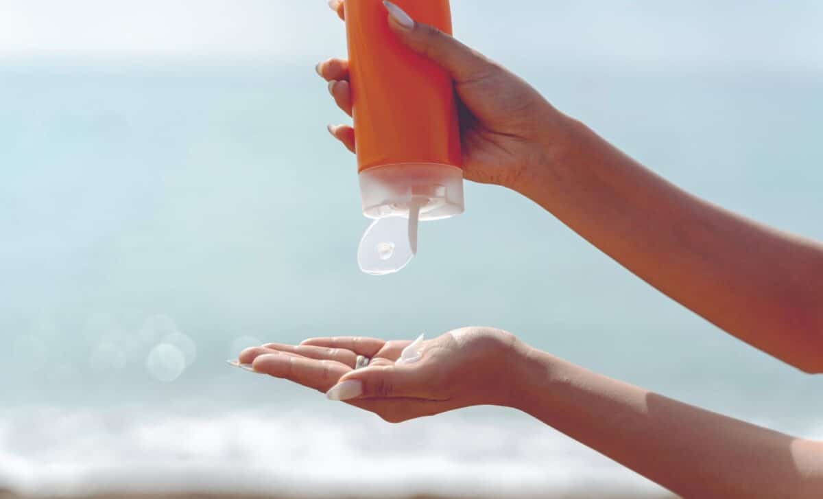 Woman squeezing suncreen into her hand