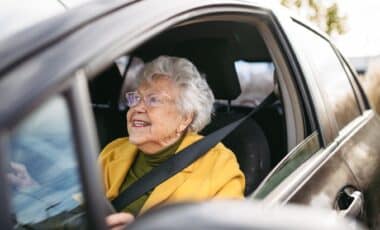 Old female driver behind the wheel