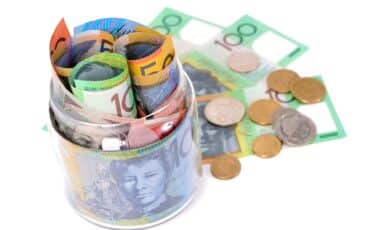 Australian Dollar Notes Rolled up and Some Coins