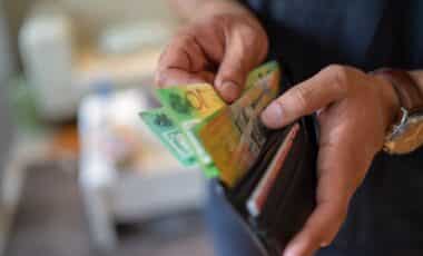 Person taking australian bank notes out of a wallet