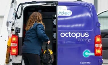 Octopus Energy Worker Holding A Bag Out Of An Octopus Energy Van