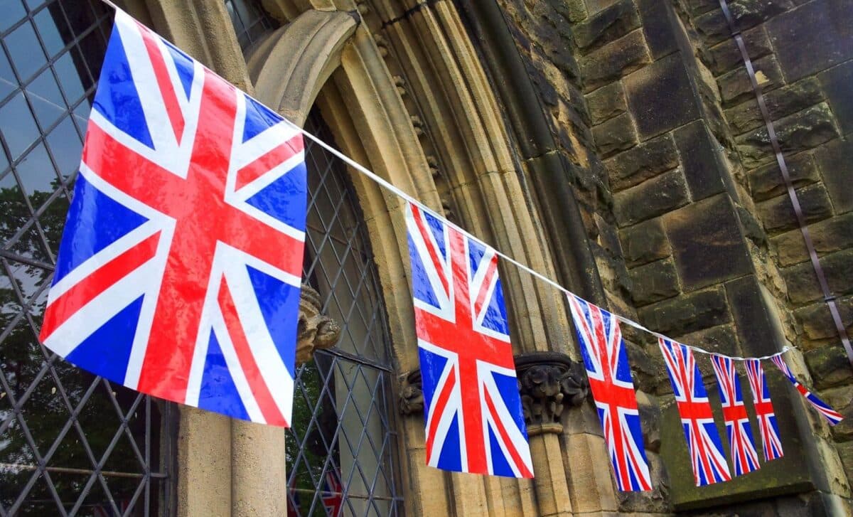 Union Jack Flags Strung In Front Of A Building to refer to UK Could See Extra Bank Holiday in 2025 with Plans for a Four-Day Weekend