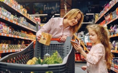 woman and a young girl shopping together in a grocery store