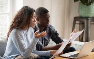 couple read DWP paperwork at home