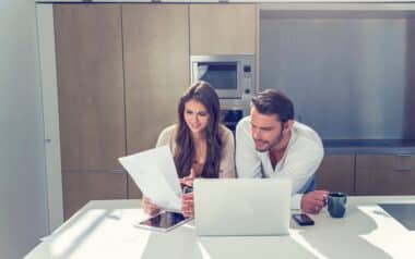 Concerned couple with Benefits paperwork.