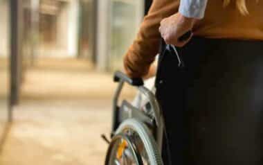 DWP-Person in a wheelchair, focusing on the back view of the individual.