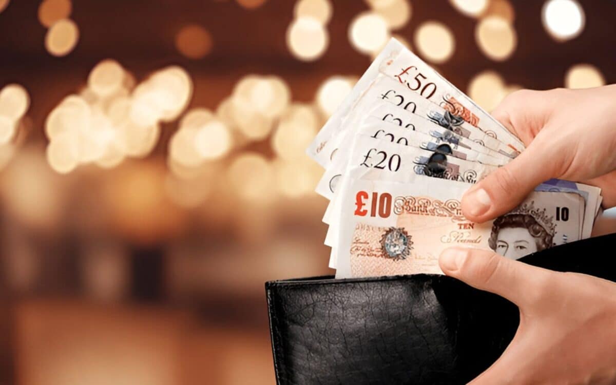 Households-hand taking money notes out wallet