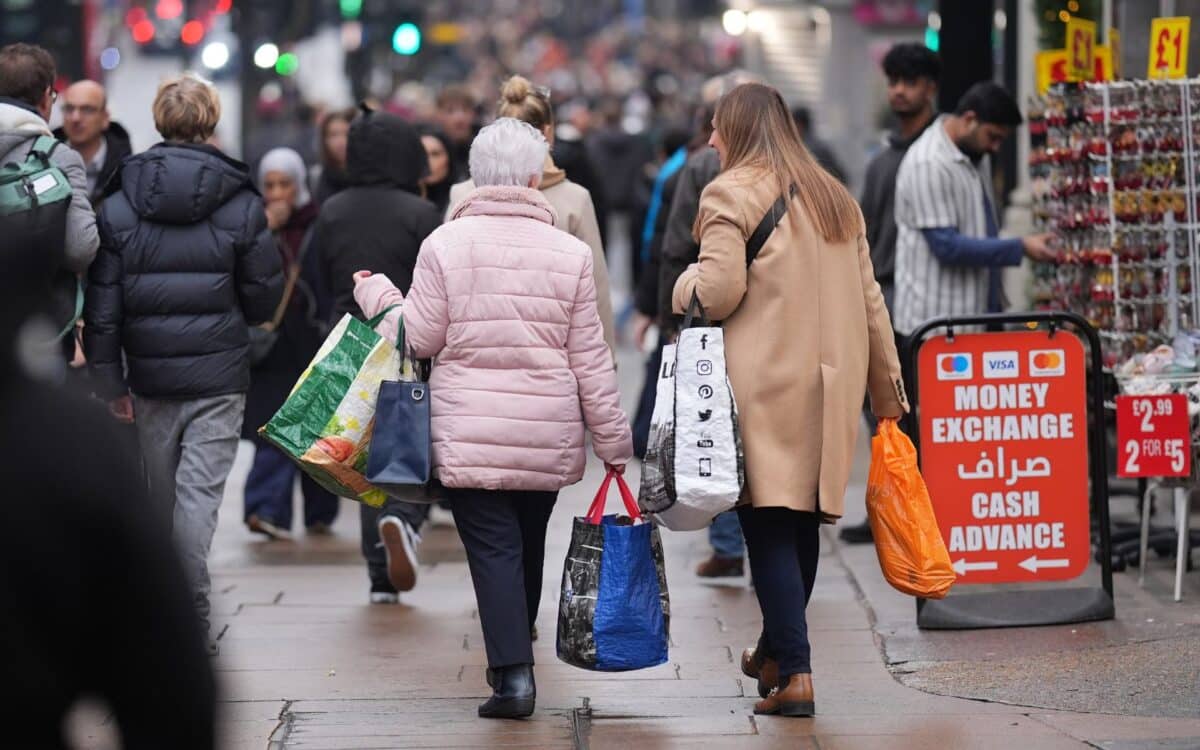 Retailers-two women, one wearing a pink jacket and the other a beige coat, are seen walking away from the camera holding shopping bags