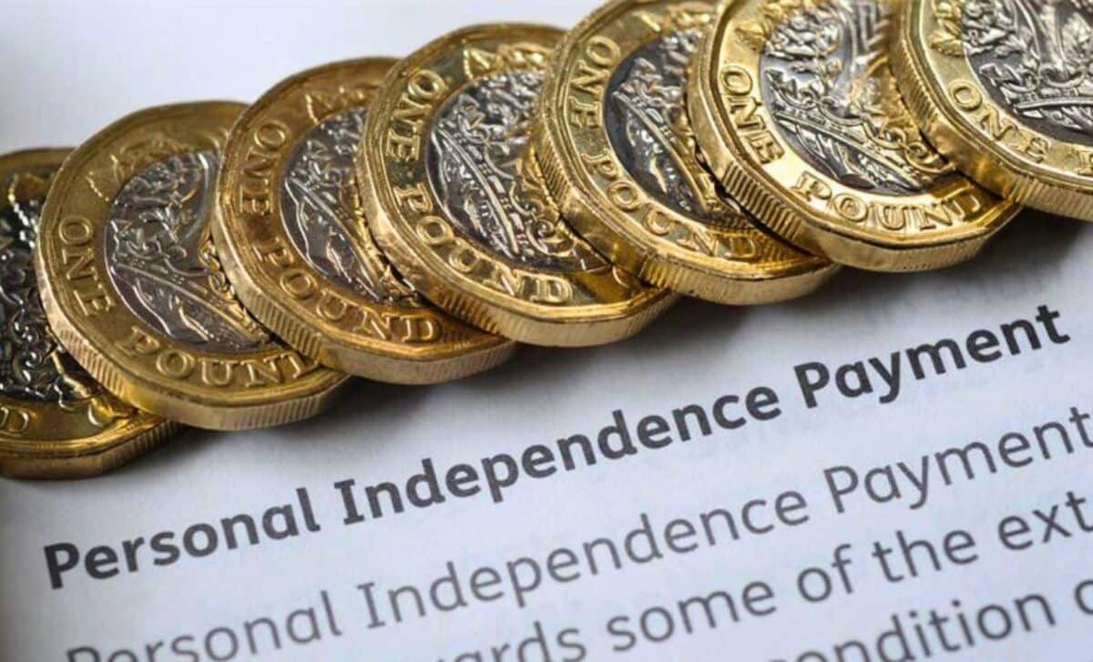 Stacked £1 Coins on a Personal Independence Payment (PIP) Paper