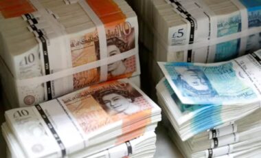 Stacks of British pound banknotes, including £10 and £5 denominations