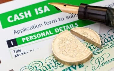 Cash ISA application form, a pen, and a broken £1 coin