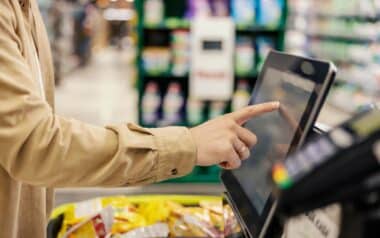 Close up of a man at self-service checkout at marketplace.