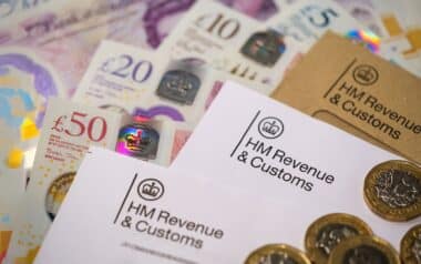 British currency notes and coins alongside official HM Revenue & Customs (HMRC)
