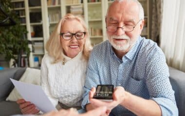 Two pensioners sit and go over documents.