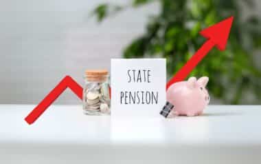 A sign labeled "State Pension" with a jar of coins and a piggy bank