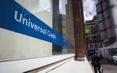 A Universal Credit sign is displayed on the window