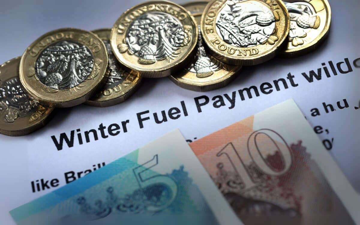 British currency arranged on top of a document Winter Fuel Payment.
