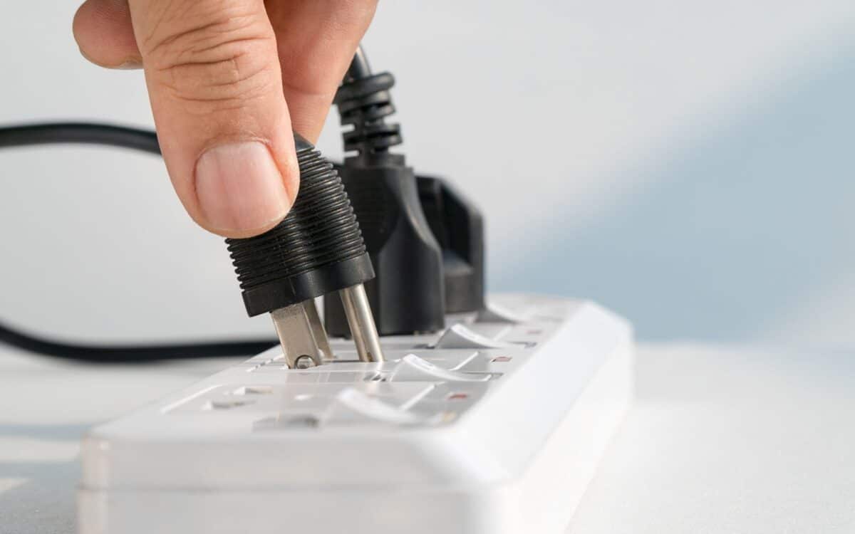 Close up of Hand Plugging into Electrical Outlet