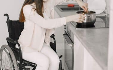 Disabled Young Woman Cooking in Kitchen