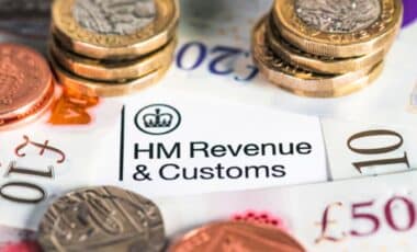 HMRC Paper Surrounded by Coins and UK Bank Notes Image Credit: George Clerk/Getty Images/iStockphoto
