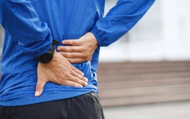Man Experiencing Back Pain While Working
