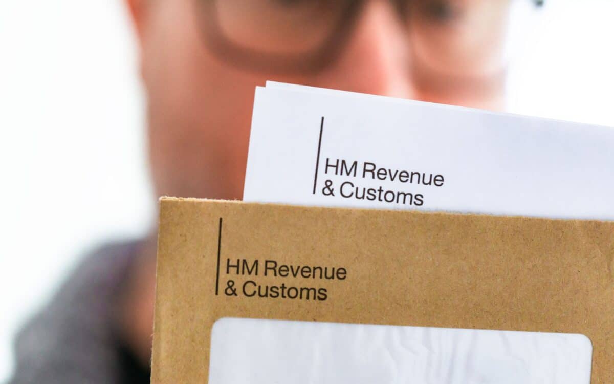 Mid adult man opening HMRC tax letter