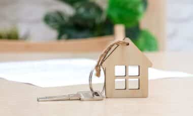 House key with small keyring resembeling wooden house