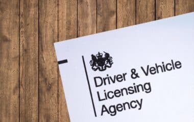 Official DVLA document with logo on a wooden surface.