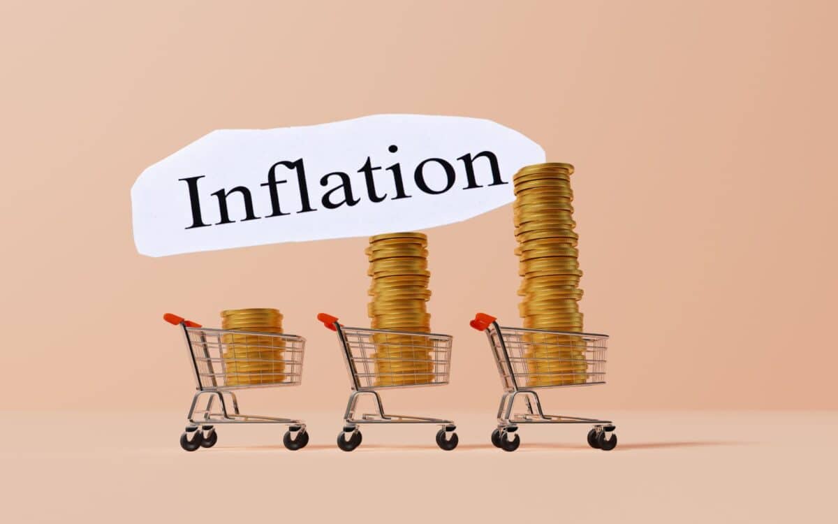 Shopping trolly with stack of gold coins, with Inflation