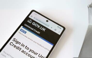 a smartphone displaying the Universal Credit sign-in page on the official UK government website (GOV.UK)