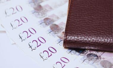 £20 Bank Notes Next to a Brown Wallet