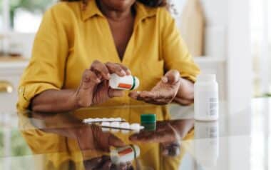 Medication adherence: Mature woman taking tablets for a chronic health condition