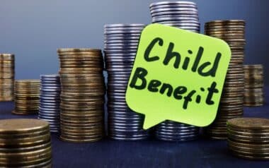 Stacks of coins and label Child benefit.