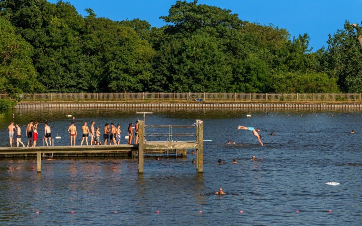 group of people enjoying a sunny day at a water body