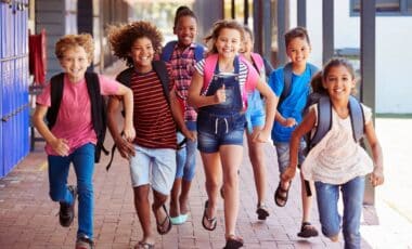Pupils Running in School Hallway