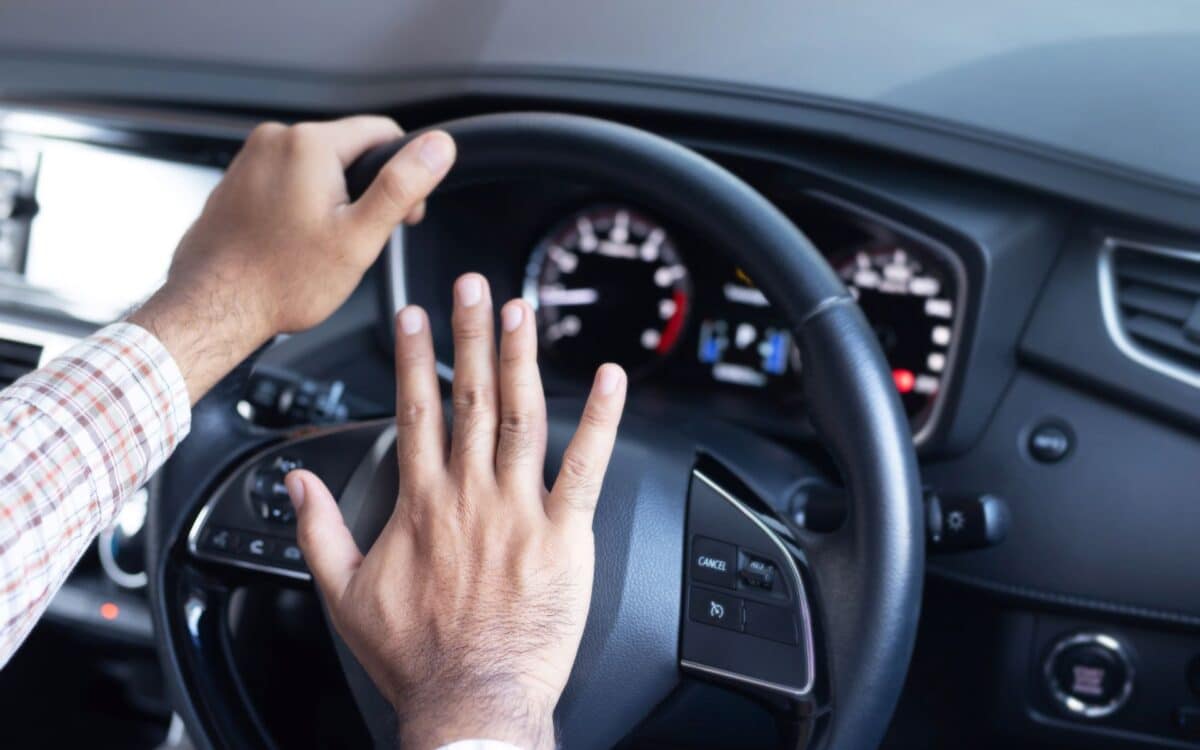 Man honking car horn