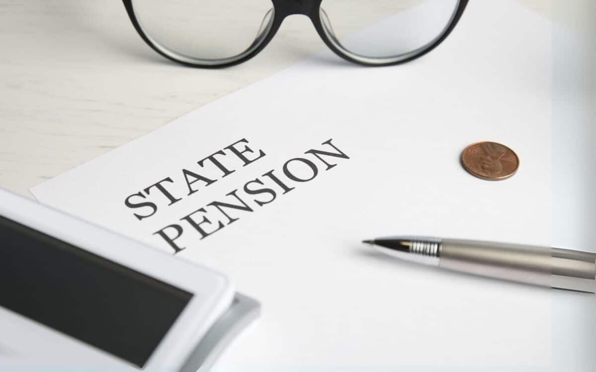 Paper with Words STATE PENSION, Coins, Calculator and Glasses on Table