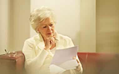 Senior reading paperwork