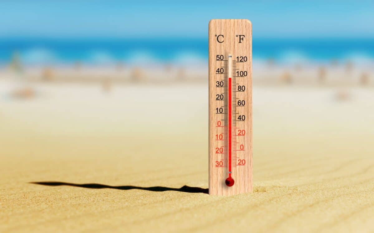 Thermometer in the sand shows plus 37 degrees celsius