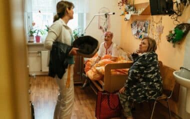 Caregiver Talking with Elderly Women in Nursing Home