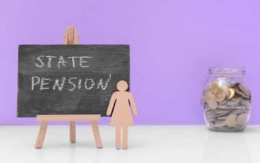 Chalkboard with Text STATE PENSION and Jar with Savings on Table