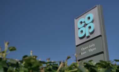 Co-op sign with logo and opening hours.