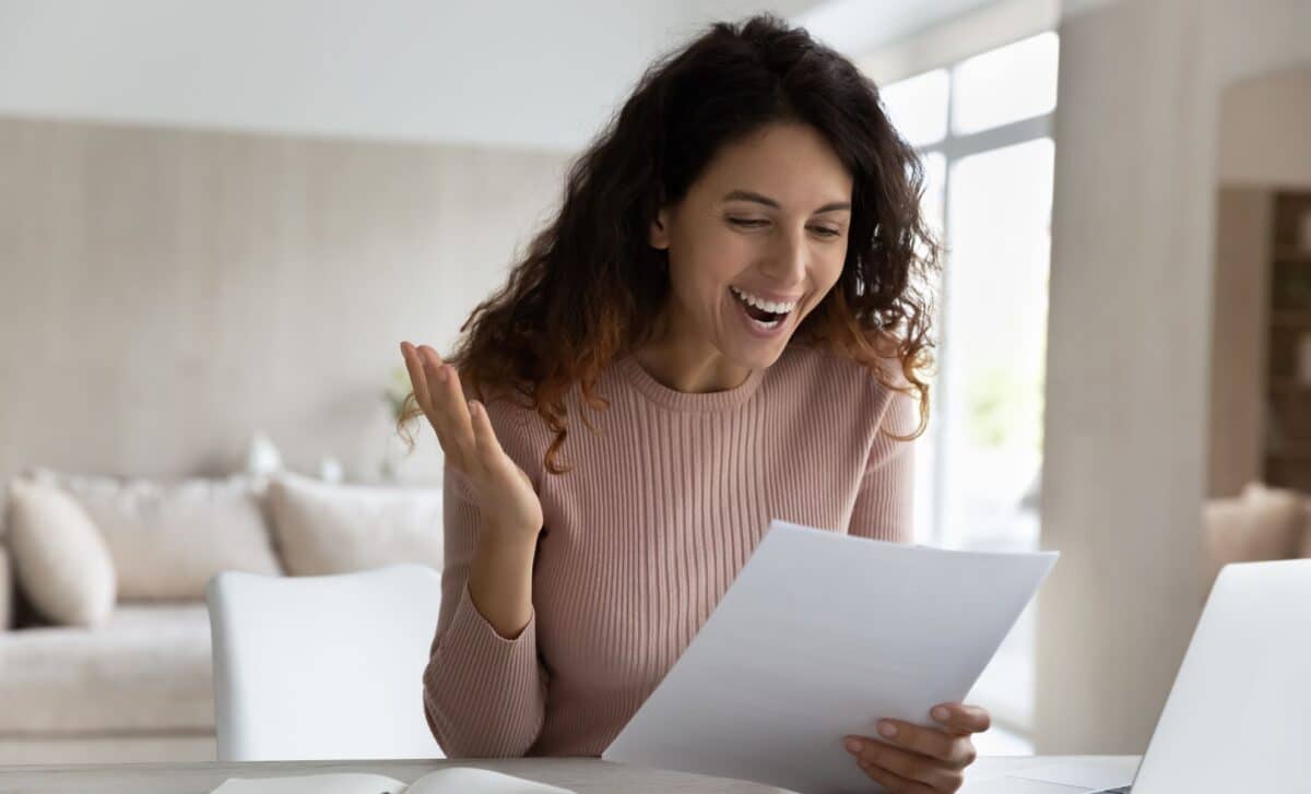 Smiling woman reading a document